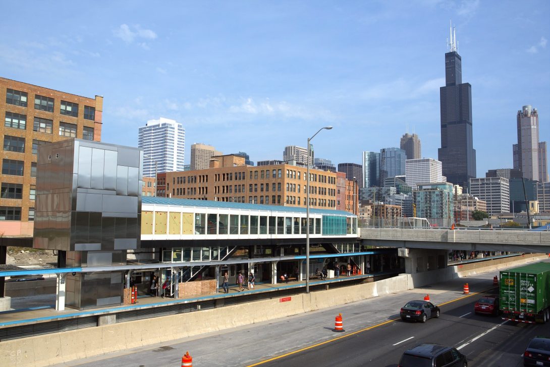 Blue line stop and Eisenhower Highway in the forefront with the Chicago skyline in the background.