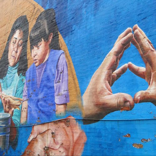 Mural of holding hands and a mother with a child