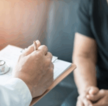 Doctor and patient together, and the doctor taking notes 