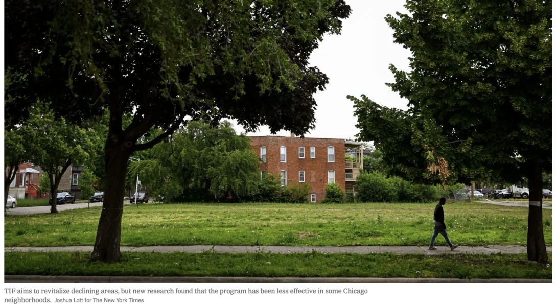 A person walks along a path through a tree-lined green space in Chicago, with a brick residential building visible in the background. Photo credit: Jamie Kelter Davis for The New York Times.