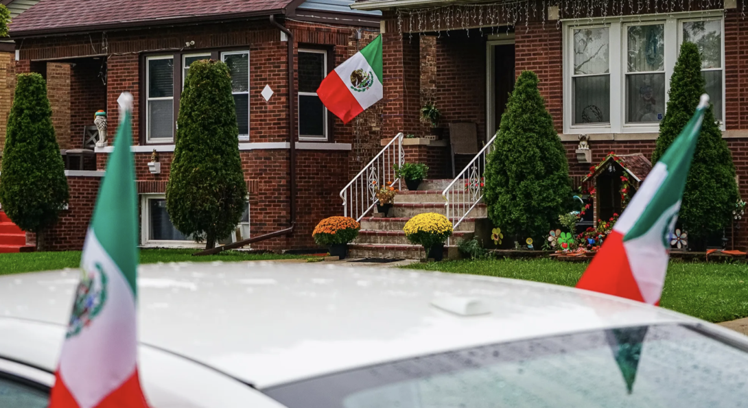 Mexican flags hang from a house and a car on the 2700 block of N Major Ave in Belmont Cragin on Sept. 16, 2026. Credit: Giacomo Cain/Block Club Chicago