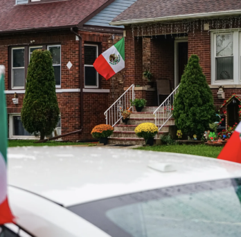Mexican flags hang from a house and a car on the 2700 block of N Major Ave in Belmont Cragin on Sept. 16, 2026. Credit: Giacomo Cain/Block Club Chicago